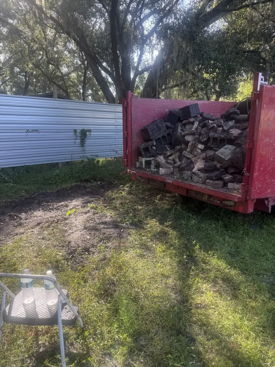 Bricks loaded into Junk By Tuck’s red trailer