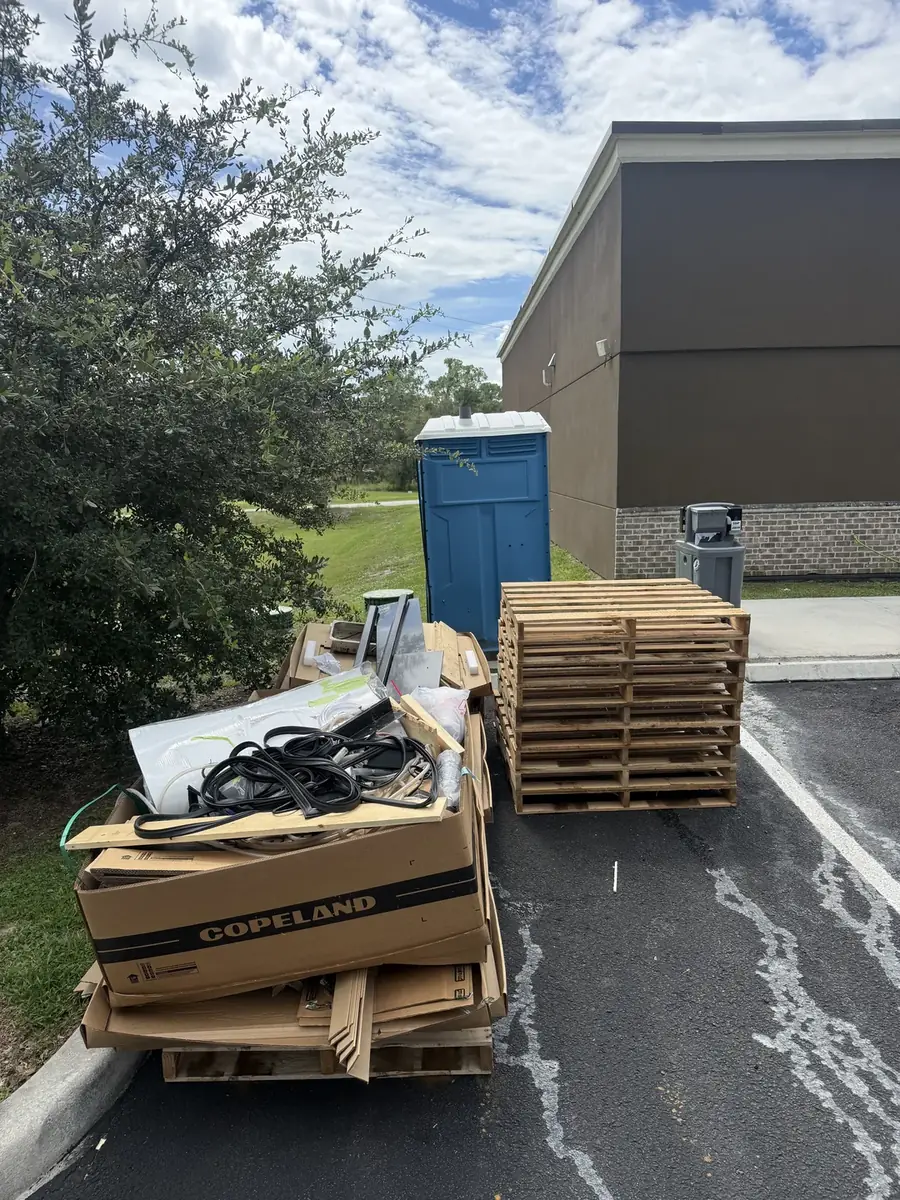Appliances and pallets staged outside a commercial building