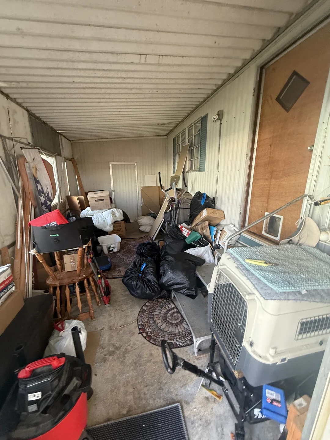 Furniture and household items on a porch before removal