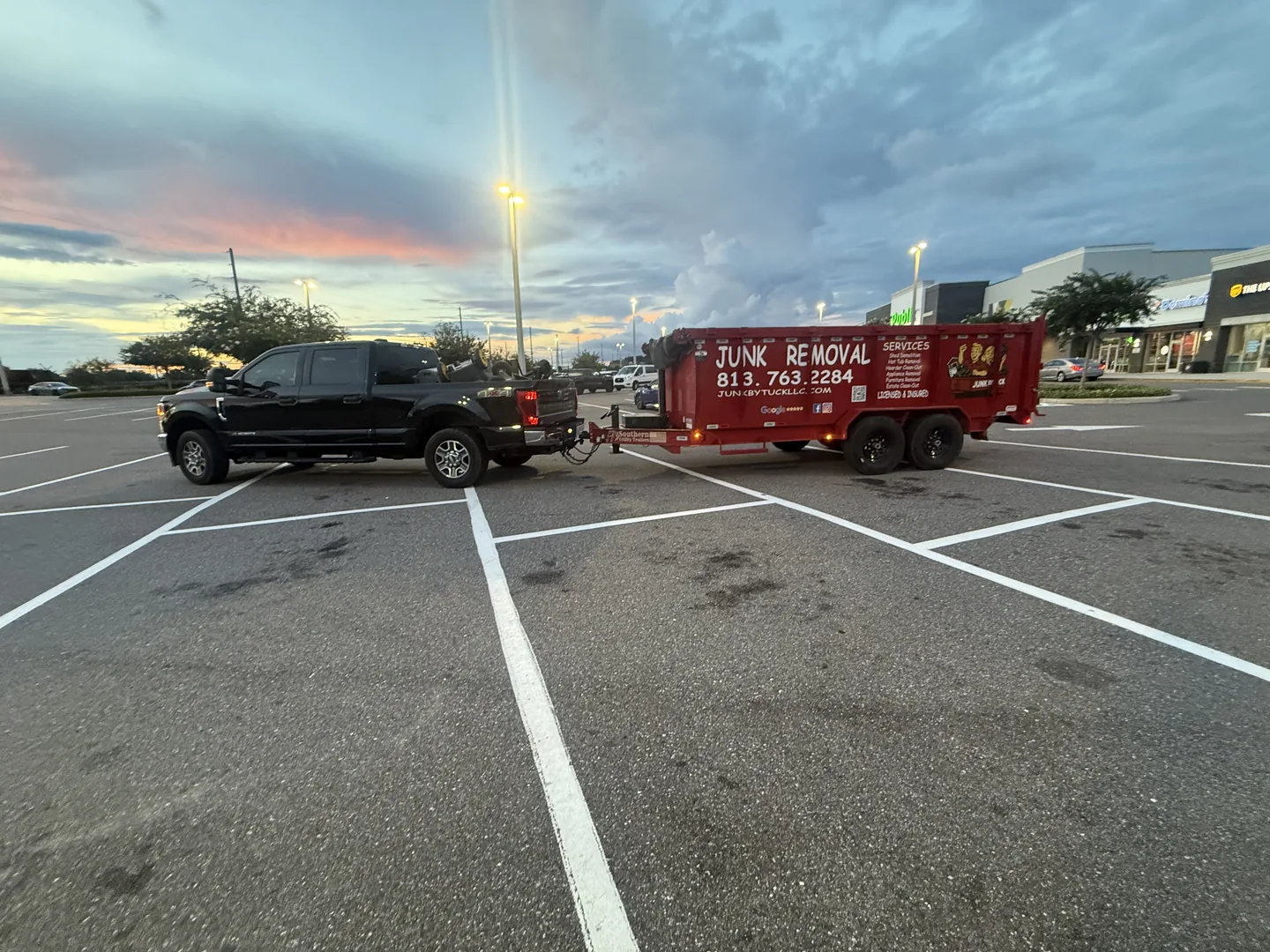 Junk By Tuck truck and red trailer used for loading and transport